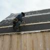 Amish man putting on crossboards